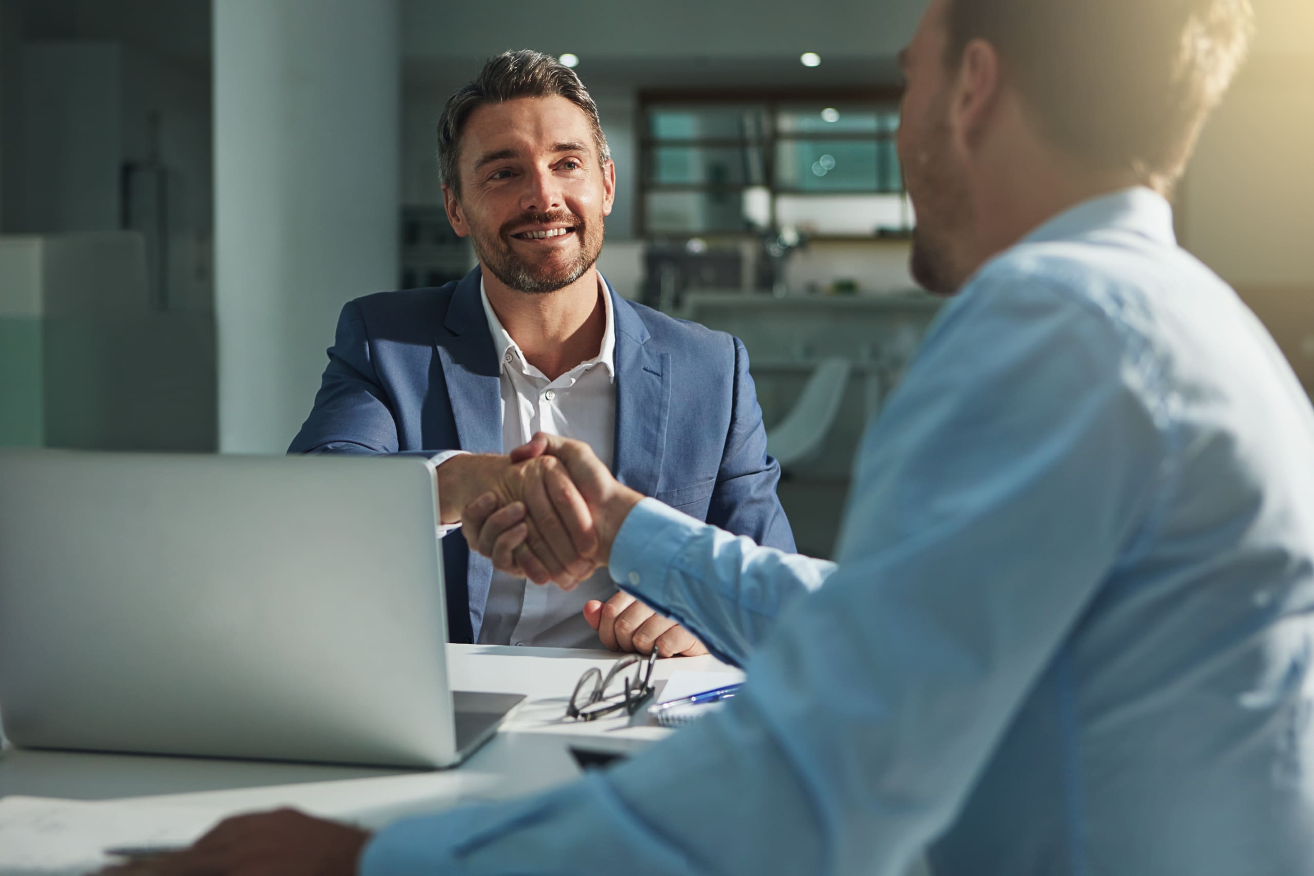 Business people, handshake and interview success or recruitment, employment and hiring in office Corporate, men and executive shaking hands with new employee or collaboration on deal or partnership