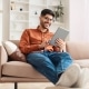 smiling young arab man using digital tablet at home